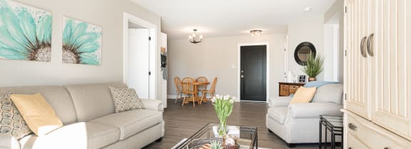a living room with a couch and a chair and a sliding glass door