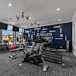 Resident Fitness Center with natural light and a wall of windows overlooking the pool at Eagles Landing, Ammon, ID, 83406