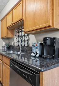 Kitchen with Wooden Cabinets at Granite Peaks Apartments, Minnesota