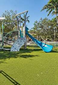 a playground at a park with a blue slide