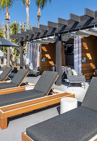 A patio with wooden furniture at Verandas Apartments, West Covina, 91791
