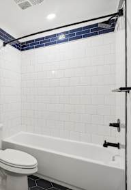 A white toilet sits next to a sink in a bathroom.