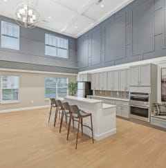 a living room with a table and a tv on the wall