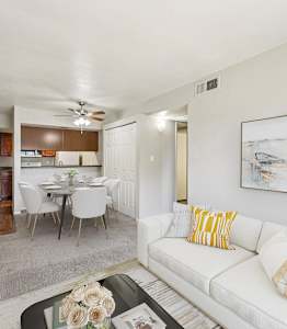 Living room with a couch and coffee table at Sycamore Square Apartments, Mesa, Arizona