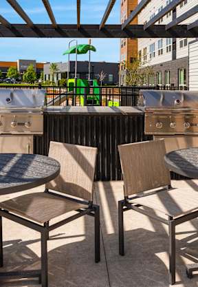 A patio with a table and chairs under a roof at The Beaumont Apartments, Bozeman, MT