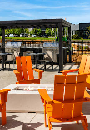 A set of orange chairs and a table at The Beaumont Apartments, Montana
