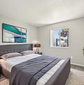 Bedroom with comfortable bed at Sycamore Square Apartments, Mesa, AZ