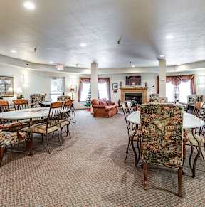 A large room with a dining table and chairs.