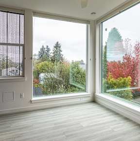 Corner room with floor to ceiling windows and fall foliage views at Kaya Camilla, Portland