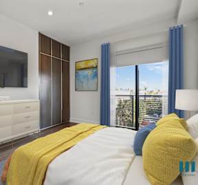 a bedroom with a large bed and a tv