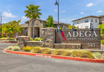 an image of the adecca community sign with a building in the background