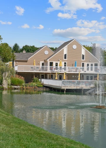a home with a large deck overlooks a small body of water