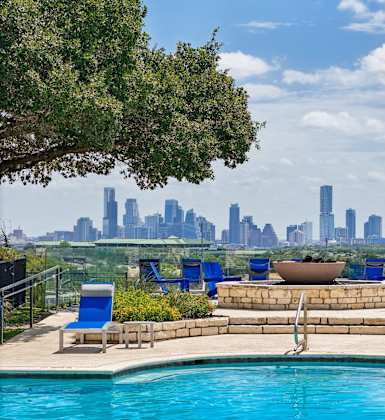 A pool with a view of the city skyline.