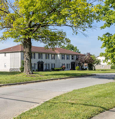 a large white house with a tree in front of it