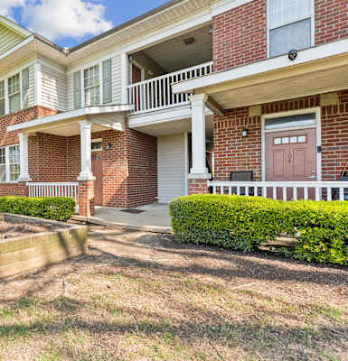 A house with a red brick exterior and a white door.