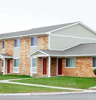 A row of houses with red doors and white trim.