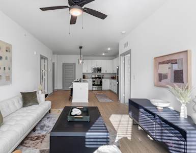 A modern living room with a white couch and a coffee table.