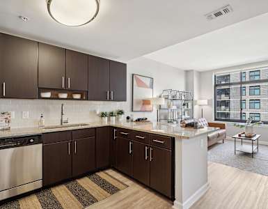 an open kitchen and living room with a large window
