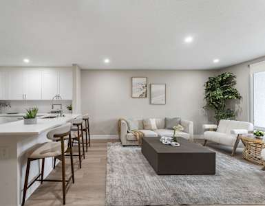 A modern kitchen with white cabinets and a large island.at Tamarack Sands Apartment Homes, Carlsbad, CA, 92008