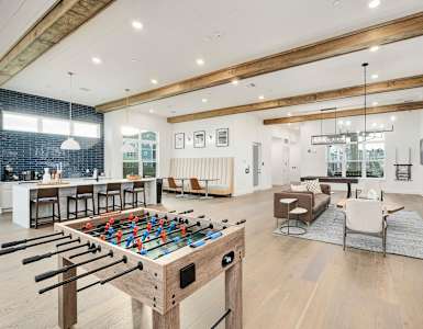 A foosball table is in the middle of a living room.