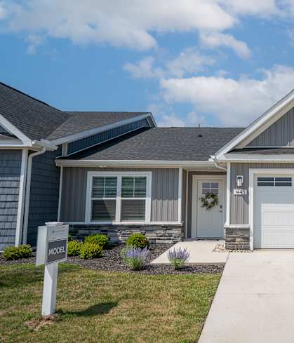 A house with a garage and a sign that says "MORE".