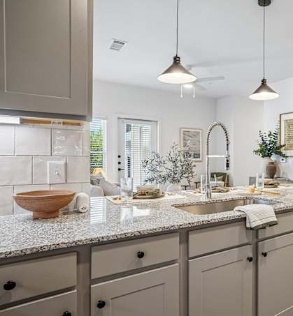 A modern kitchen with a granite countertop and a bowl on it.