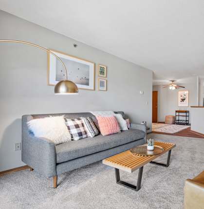 a living room with a couch and a chair and a table