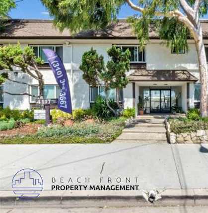 a beach front property management building with a dog in front of it