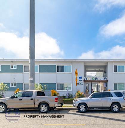 A building with the number 1439 on it and a sign that says property management.