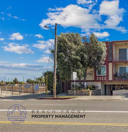 A two-story building with a balcony is located on Beach Front property.