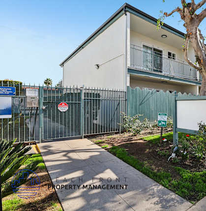 A sign in front of a building reads "Each Front Property Management.".