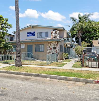 A house with a blue sign on the front.