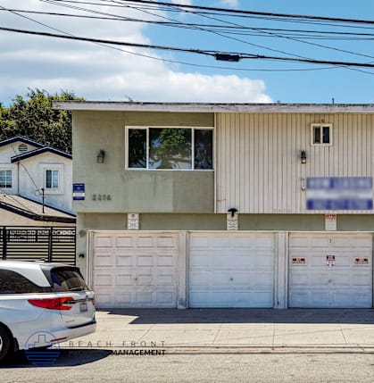 A two-story building with a garage door on the bottom floor.