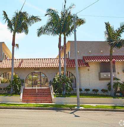 a house with palm trees in front of it