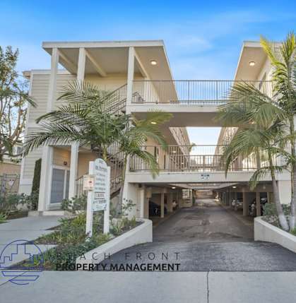 A beachfront property with a sign for Beachfront Property Management.