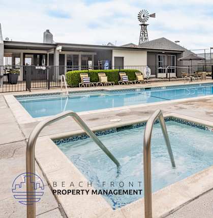 A pool with a slide and a logo for Beach Front Property Management.