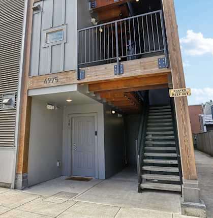 The image shows a building with the number 4975 on it.