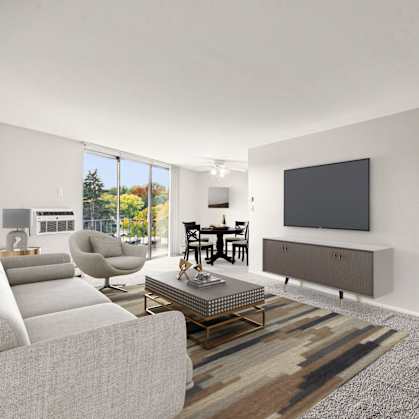 A modern living room with a grey sofa, a coffee table, a television, and a sliding door.