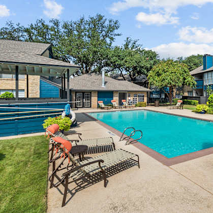 our apartments have a swimming pool and a patio with chairs and tables