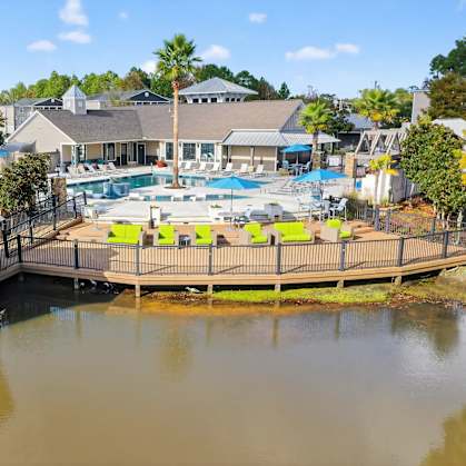 A large building with a pool and a gazebo in front of it.