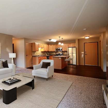 a living room with a couch and a table. Fargo, ND Urban Plains Apartments