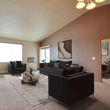 a living room with a couch and a table. West Fargo, ND West Lake Apartments.