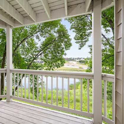 the view from the porch of a house overlooking a lake at Cityscape, St Louis Park, MN, 55416