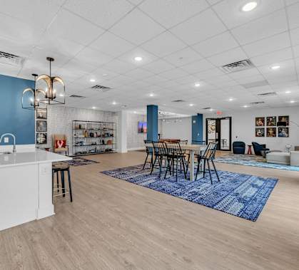 A kitchen with a white island and blue walls.