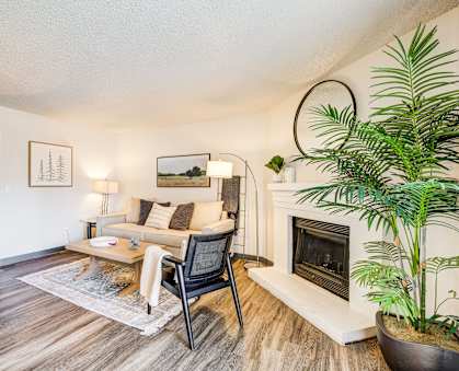 A living room with a fireplace and a chair.