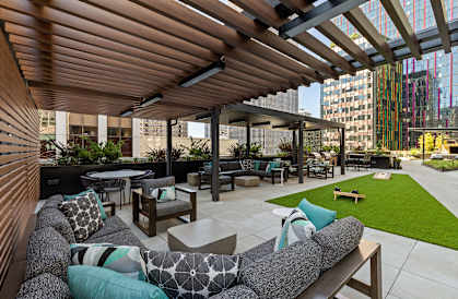 a lounge area with couches and tables on a patio