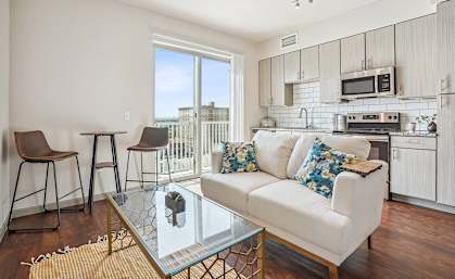 a living room with a couch and a glass table