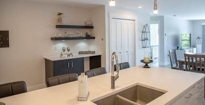 a kitchen with a sink and a counter top in a house