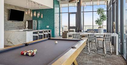 A pool table with balls set up in the middle of it.