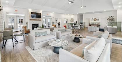 A spacious living room with white furniture and a fireplace at The Parker North Augusta
